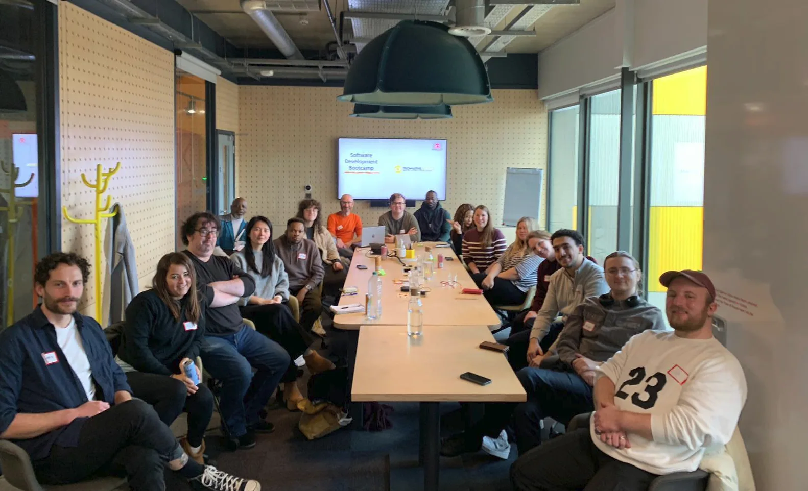 The alumni of Tech Finishing School smiling. 