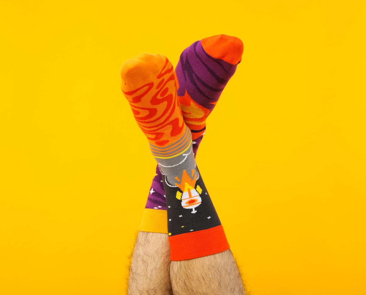 A pair of colourful socks with a space rocket.