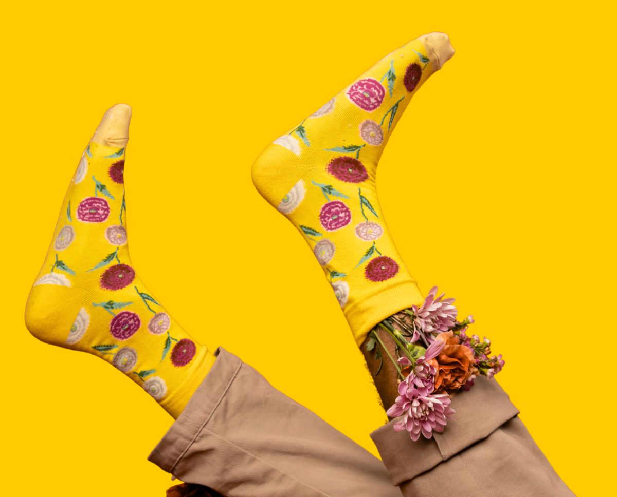 A pair of yellow socks with flowers.
